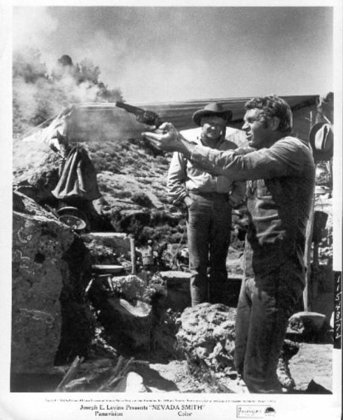 Jonas Cord (played by Brian Keith) watches as 
Max (McQueen) tries to shoot a target.